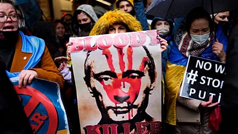 Pro-Ukraine people shout slogans during a small protest outside the Russian consulate in Istanbul, Turkey, Thursday, Feb. 24, 2022.