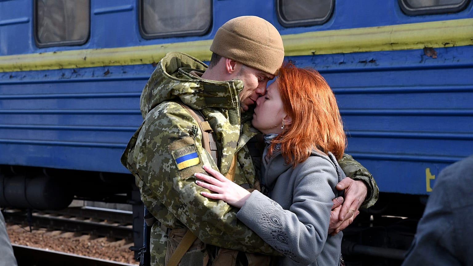 Un couple s'enlace avant qu'elle ne monte dans le train en gare de Kramatorsk en direction de l'ouest de l'Ukraine, dimanche 27 février 2022