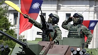 FILE - Taiwanese soldiers salute during National Day celebrations in front of the Presidential Building in Taipei, Taiwan on Oct. 10, 2021.