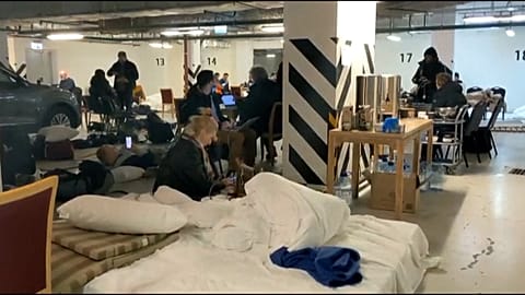 People shelter inside the Radisson Blu hotel in central Kyiv