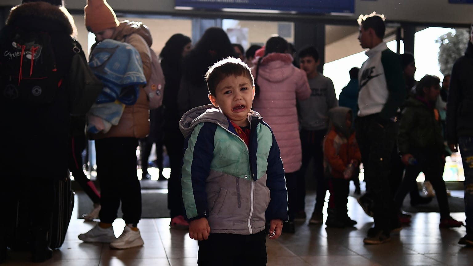 A refugee boy who fled conflict from neighboring Ukraine cries at the railway station after arriving to Zahony, Hungary, Sunday, Feb. 27, 2022