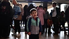A refugee boy who fled conflict from neighboring Ukraine cries at the railway station after arriving to Zahony, Hungary, Sunday, Feb. 27, 2022