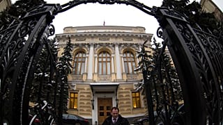 A man walks in front of Russia's Central Bank building in Moscow, Russia, Friday, Jan. 30, 2015.