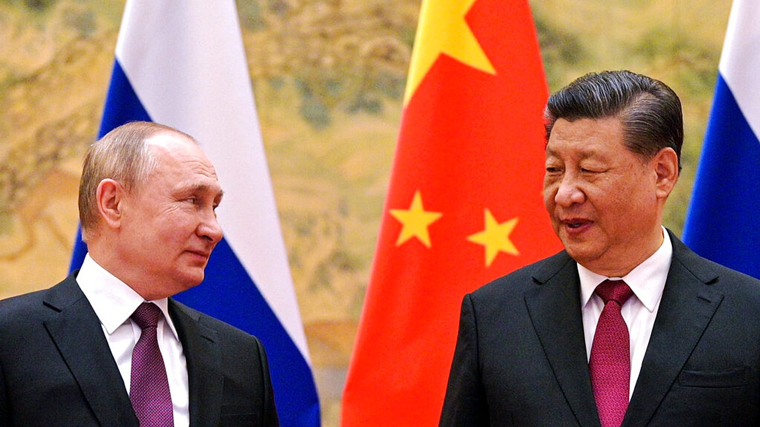  Chinese President Xi Jinping, right, and Russian President Vladimir Putin talk to each other during their meeting in Beijing