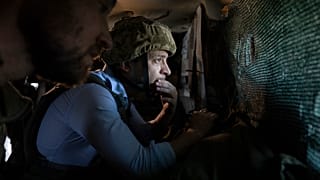 President Volodymyr Zelenskyy looks at a front-line position from a shelter as he visits eastern Ukraine - 2019