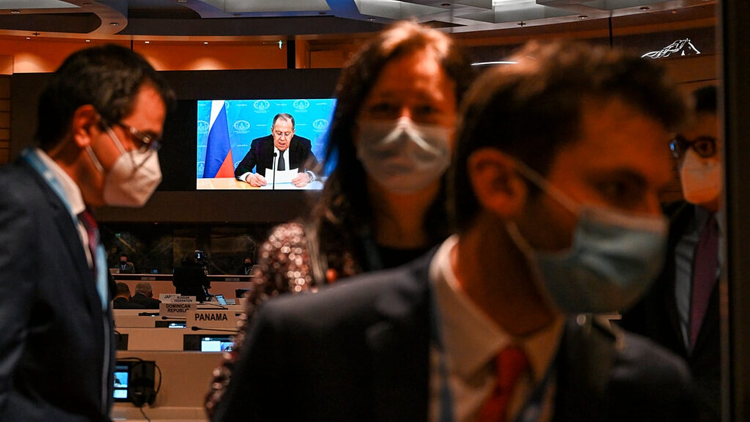 Ambassadors and diplomats leave the room while Russia's foreign minister Sergei Lavrov addresses with a pre-recorded video message the Conference on Disarmament