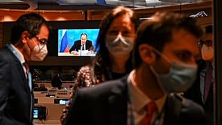 Ambassadors and diplomats leave the room while Russia's foreign minister Sergei Lavrov addresses with a pre-recorded video message the Conference on Disarmament