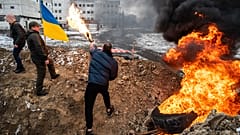 Volunteers prepare Molotov cocktails in one of the local parks in Uzhgorod, western Ukraine. February 28, 2022.