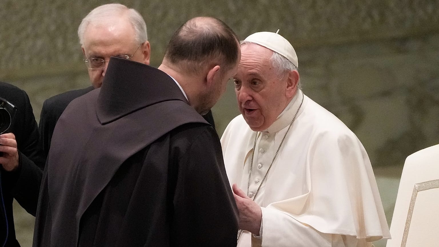 Friar Marek Viktor Gongalo, from Ukraine, is greeted by Pope Francis during the weekly general audience at the Vatican, March 2, 2022.
