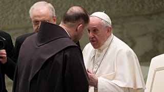 Friar Marek Viktor Gongalo, from Ukraine, is greeted by Pope Francis during the weekly general audience at the Vatican, March 2, 2022.