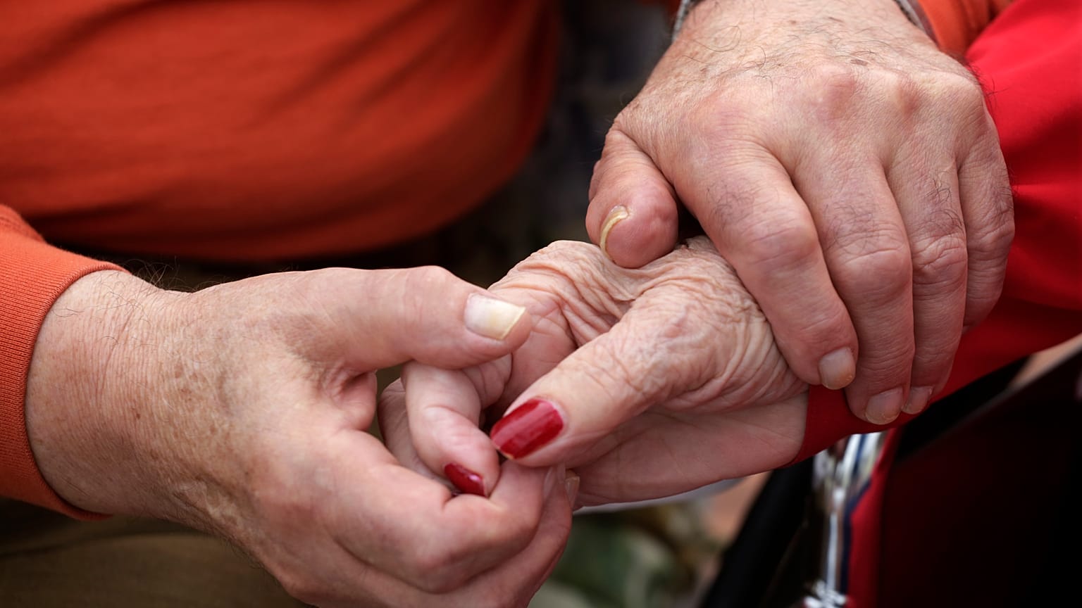 In this 2013 photo, Holocaust survivor Joe Chaba holds hands with his wife, Helen Chaba, at their home in Chicago.