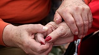 In this 2013 photo, Holocaust survivor Joe Chaba holds hands with his wife, Helen Chaba, at their home in Chicago.