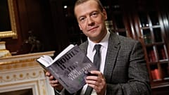 The then Russian Prime Minister Dmitry Medvedev poses as he reads Leo Tolstoy's "War and Peace" aloud as he takes part in a 60-hour marathon on national television in 2015