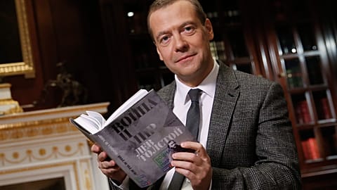 The then Russian Prime Minister Dmitry Medvedev poses as he reads Leo Tolstoy's "War and Peace" aloud as he takes part in a 60-hour marathon on national television in 2015