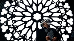 A man uses a virtual reality glasses at the stand of Orange to visit Notre Dame Cathedral at the MWC (Mobile World Congress) in Barcelona on March 2, 2022. 