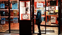 A woman wears a facemask outside a cinema in Paris.
