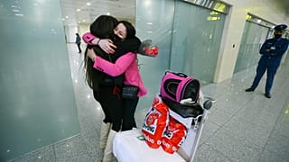 An Algerian student studying in Ukraine is embraced by a family member as she arrives at Algiers airport on a repatriation flight afer leaving Ukraine, in Algiers, Algeria,