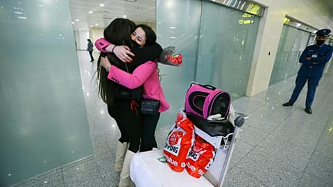 An Algerian student studying in Ukraine is embraced by a family member as she arrives at Algiers airport on a repatriation flight afer leaving Ukraine, in Algiers, Algeria,