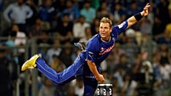 Shane Warne bowls during an Indian Premier League (IPL) cricket match in 2011
