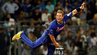 Shane Warne bowls during an Indian Premier League (IPL) cricket match in 2011