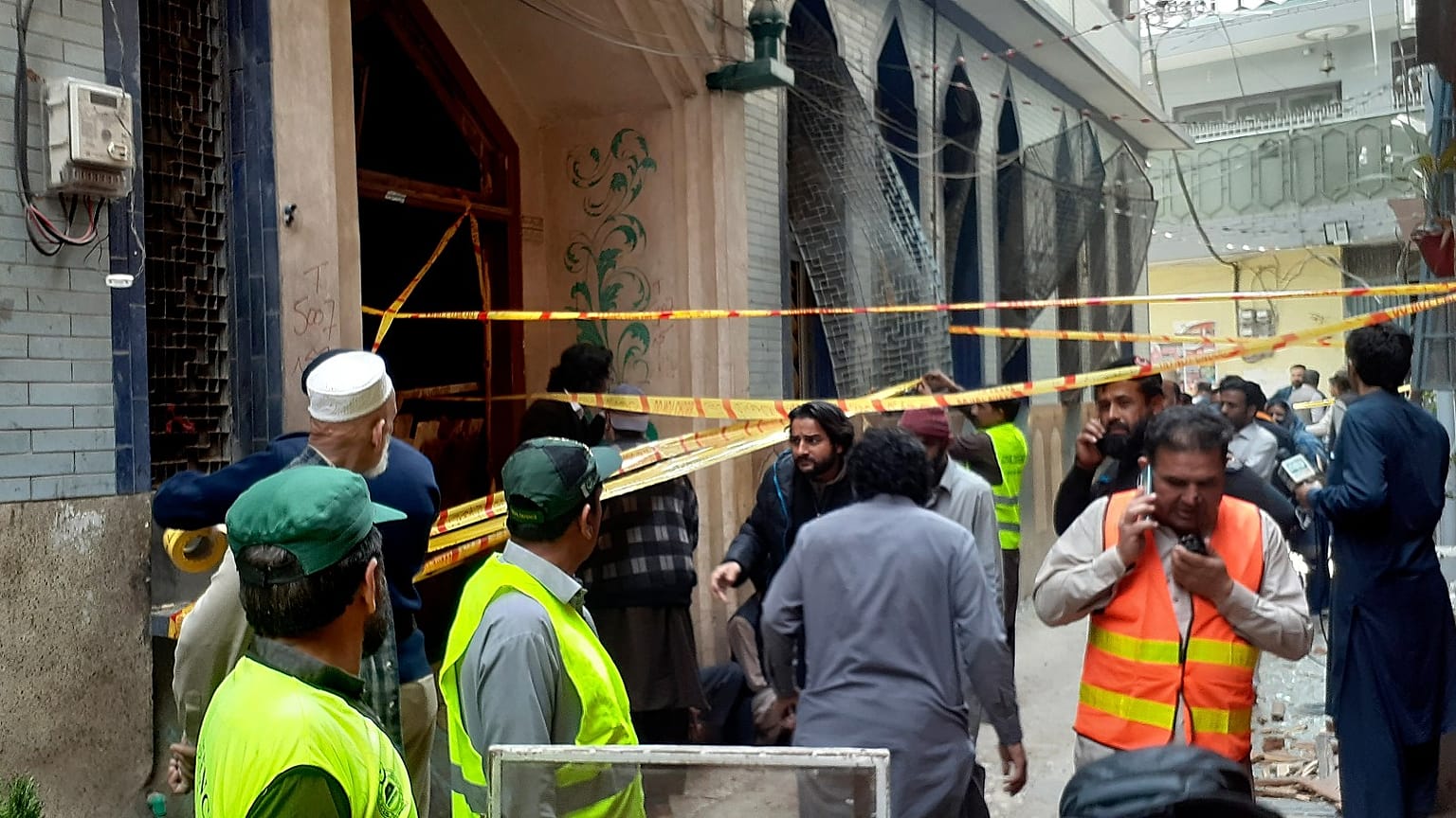 Rescue workers and volunteers gather at the site of bomb explosion in Peshawar, Pakistan, Friday, March 4, 2022. 