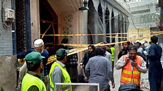 Rescue workers and volunteers gather at the site of bomb explosion in Peshawar, Pakistan, Friday, March 4, 2022. 