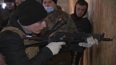 A volunteer in Lviv, Ukraine learning how to fire a gun. 