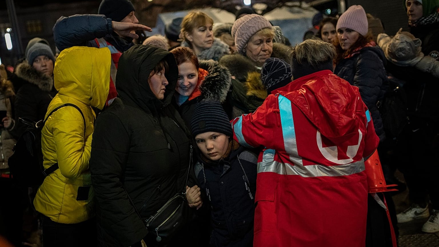Displaced Ukrainians queue to board a bus to Poland outside Lviv train station in western Ukraine on Saturday, March 5, 2022.
