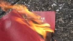 متظاهر روسي في بلغراد يحرق جواز سفره الروسي احتجاجا على غزو أوكرانيا.