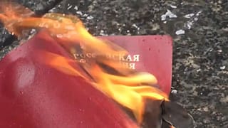متظاهر روسي في بلغراد يحرق جواز سفره الروسي احتجاجا على غزو أوكرانيا.