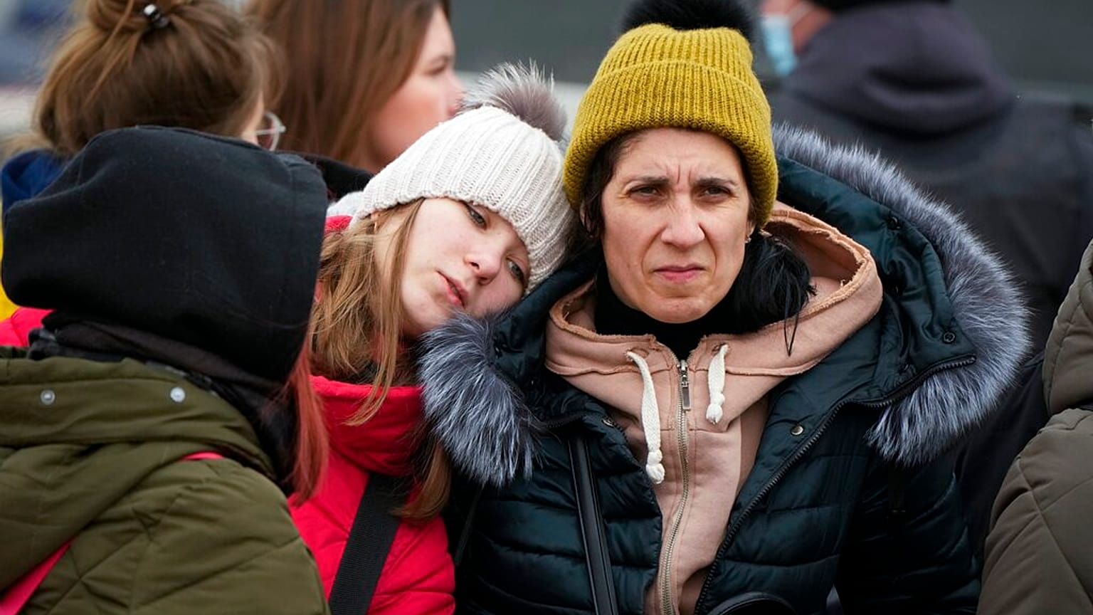 Refugees comfort each other after fleeing the war from neighbouring Ukraine, at the border crossing in Palanca, Moldova, Monday, March 7, 2022
