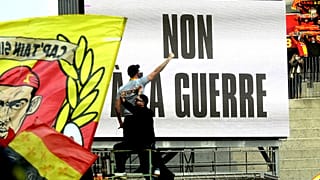 A sign saying 'No to war' over Russia's invasion of Ukraine is seen at the Ligue 1 match between RC Lens and Brest at Lens' Stade Bollaert, northern France, March 5, 2022.