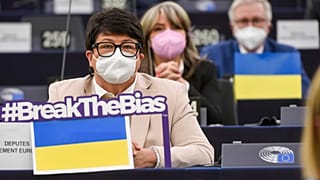 Members of European Parliament sits by Ukraine flags during a speech to mark International Women's Day, Tuesday, March 8, 2022 in Strasbourg, eastern France.