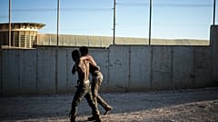 Two migrants pictured on the Spanish side of the fences separating the enclave of Melilla from Morocco.