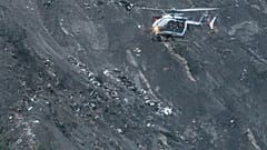 A rescue helicopter flies over debris of the Germanwings Airbus A320-211 near Seyne-les-Alpes.