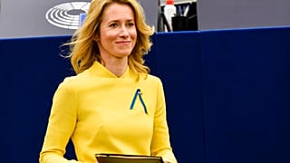 Estonian Prime Minister Kaja Kallas, wearing a dress and a ribbon under the colors of Ukraine, arrives to deliver a speech during a debate on EU's role.