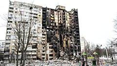 This picture shows an apartment building damaged after shelling the day before in Ukraine's second-biggest city of Kharkiv on March 8, 2022.