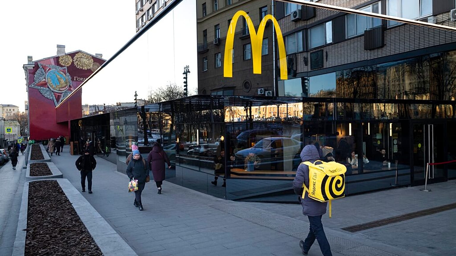 People walk past a McDonald's restaurant in the main street in Moscow
