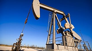 A pumpjack operates just outside of the Odessa Ector Power Partners natural gas power plant 