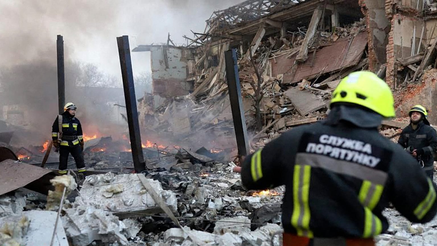 This handout picture released by the State Emergency Service of Ukraine on March 11, 2022, shows rescuers working at the scene of an airstrike in Dnipro. 