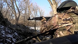Soldiers firing weapons