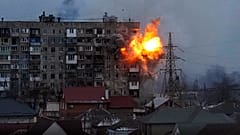 An explosion is seen in an apartment building after Russian's army tank fires in Mariupol