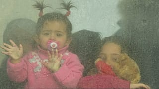 Refugee children look out from a bus leaving to Romania after fleeing the war from neighbouring Ukraine in Palanca, Moldova