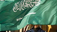 A US Honor Guard member is covered by the flag of Saudi Arabia as Defence Secretary Jim Mattis welcomes Saudi Crown Prince Mohammed bin Salman to the Pentagon in 2019.