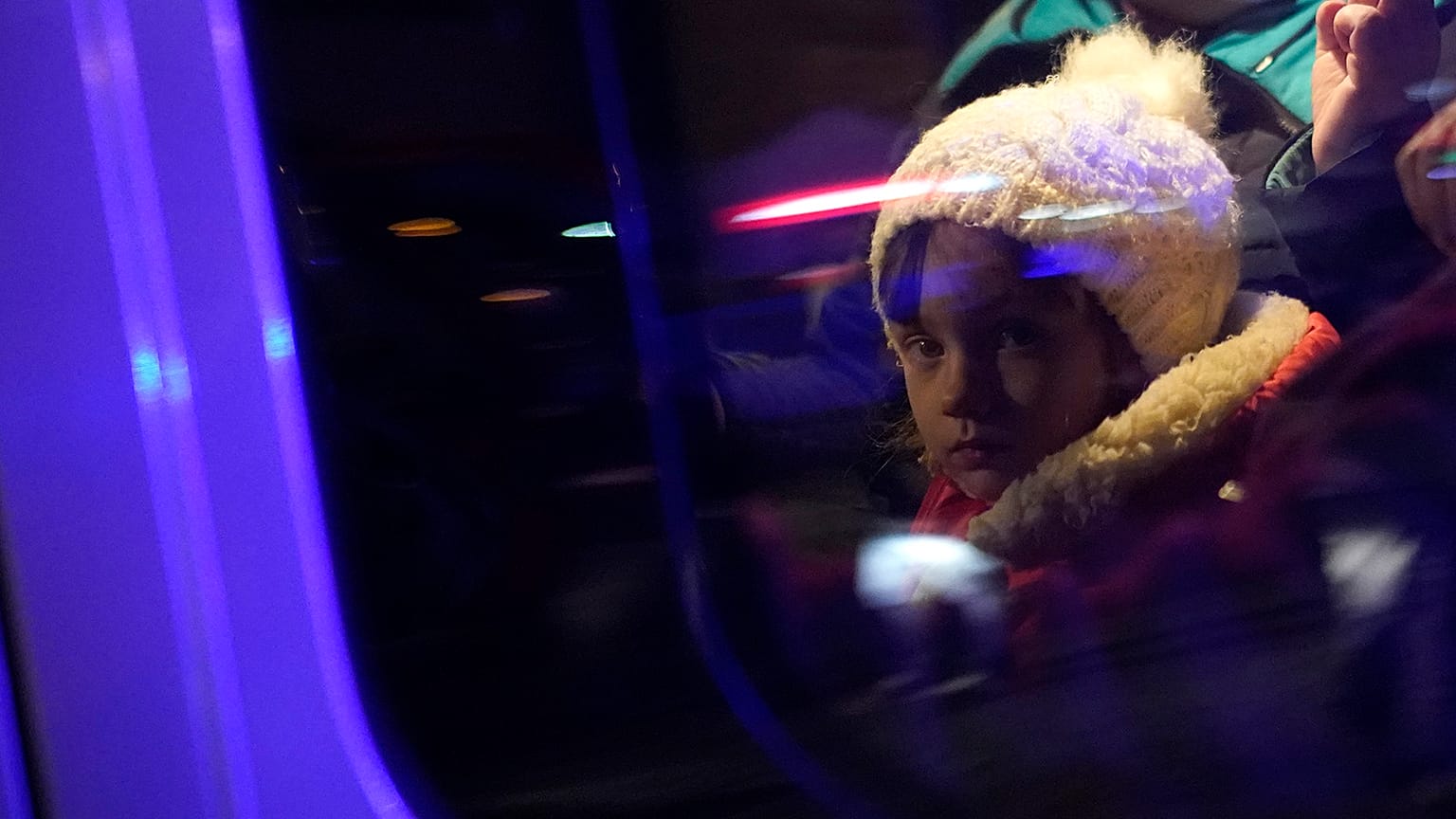 Refugees that fled the war in Ukraine sit in a car outside the train station in Przemysl, southeastern Poland