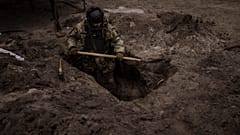 A Ukrainian soldier digs a foxhole in Irpin, outskirts of Kyiv, Ukraine, Sunday, 13 March 2022