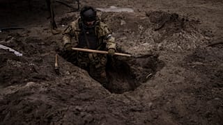 A Ukrainian soldier digs a foxhole in Irpin, outskirts of Kyiv, Ukraine, Sunday, 13 March 2022