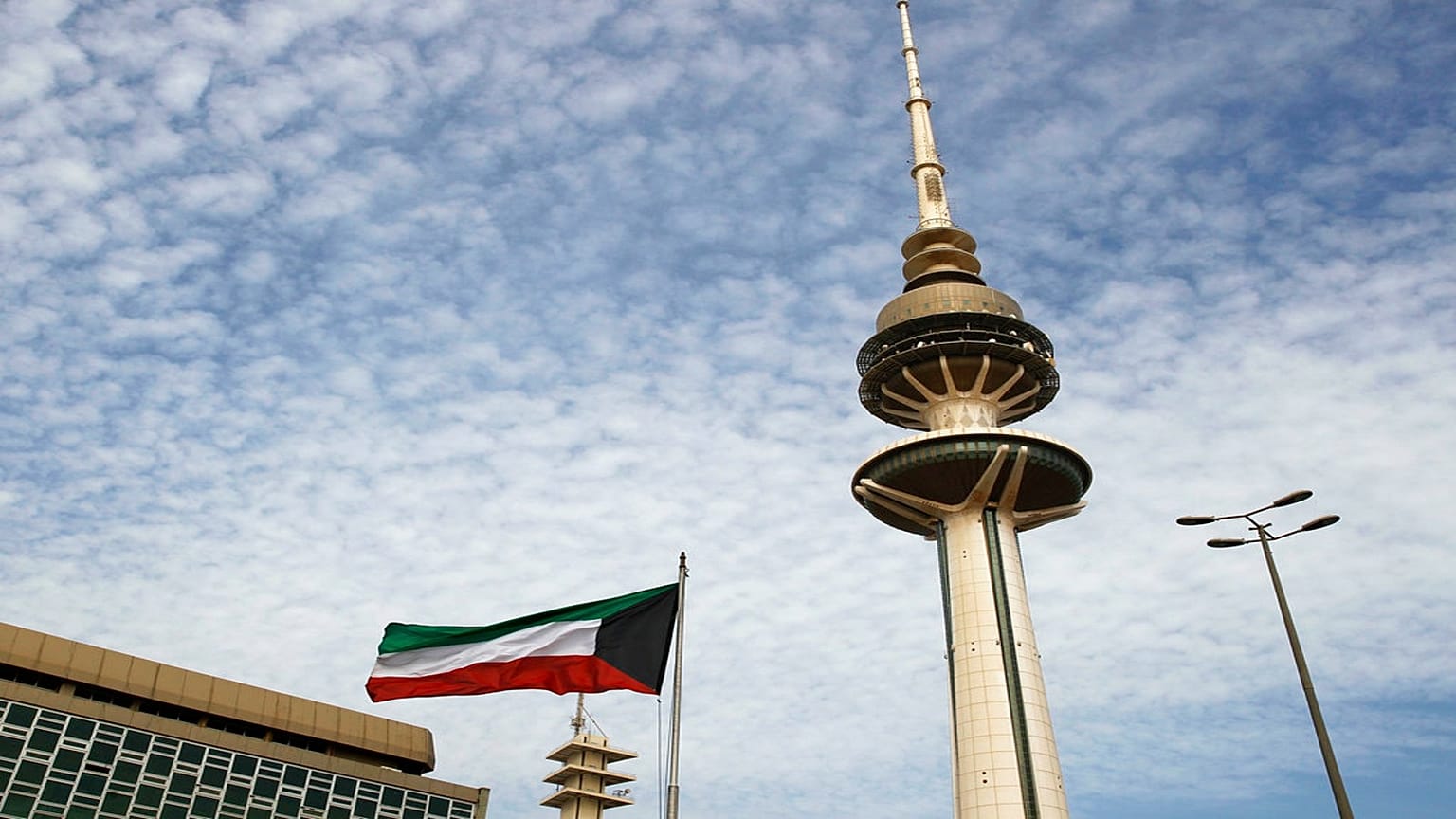 صورة لبرج تحرير الكويت بالقرب من علم البلاد وسط العاصمة
