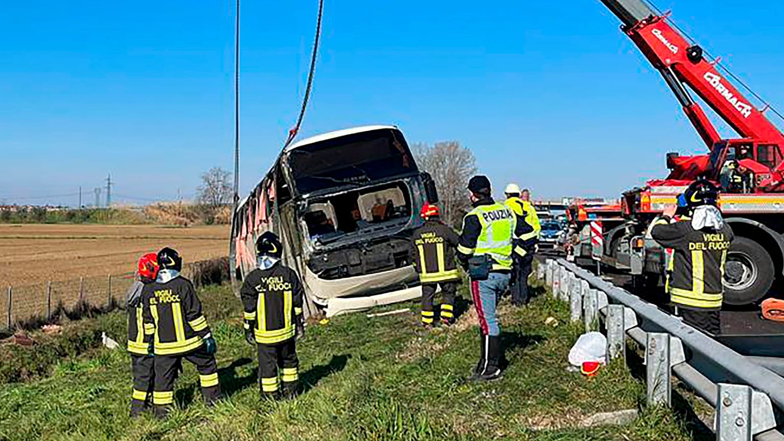 Police and rescue services attend the scene of a bus crash near Forli, Italy
