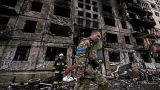 Ukrainian soldiers and firefighters search in a destroyed building after a bombing attack in Kyiv, Ukraine, Monday, March 14, 2022. 